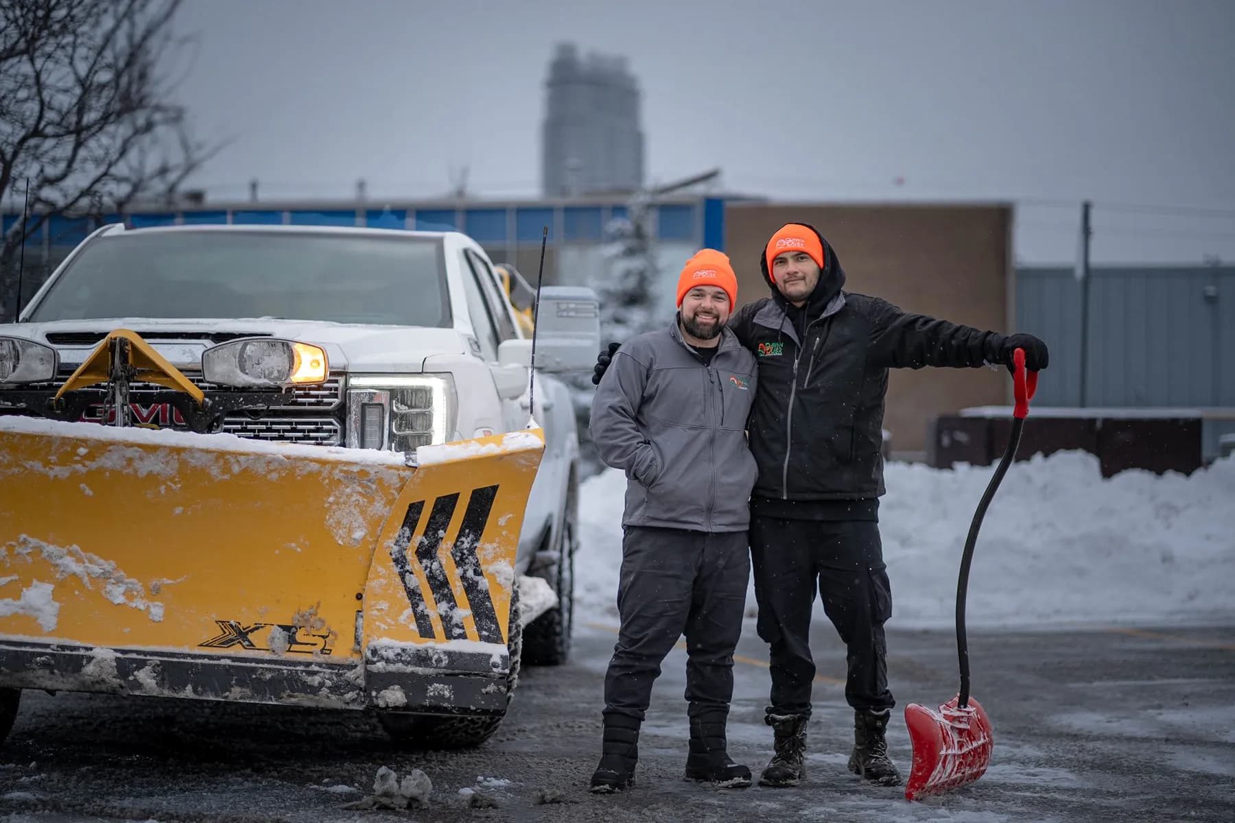 Ted and the Dawn Till Dusk crew beside the plow truck after clearing a Scarborough commercial lot