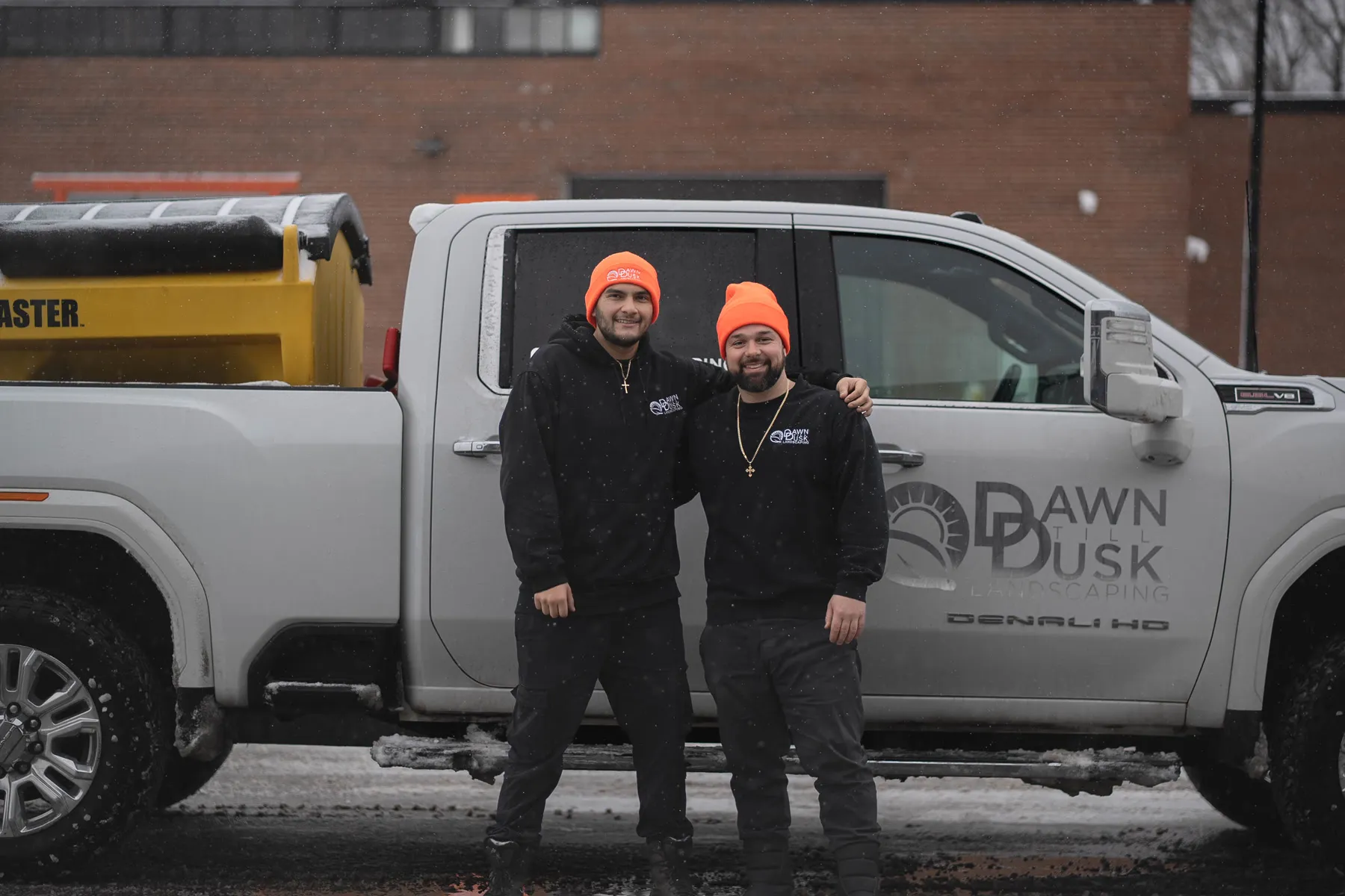 Dawn Till Dusk crew at the truck with the salt spreader loaded for a winter route