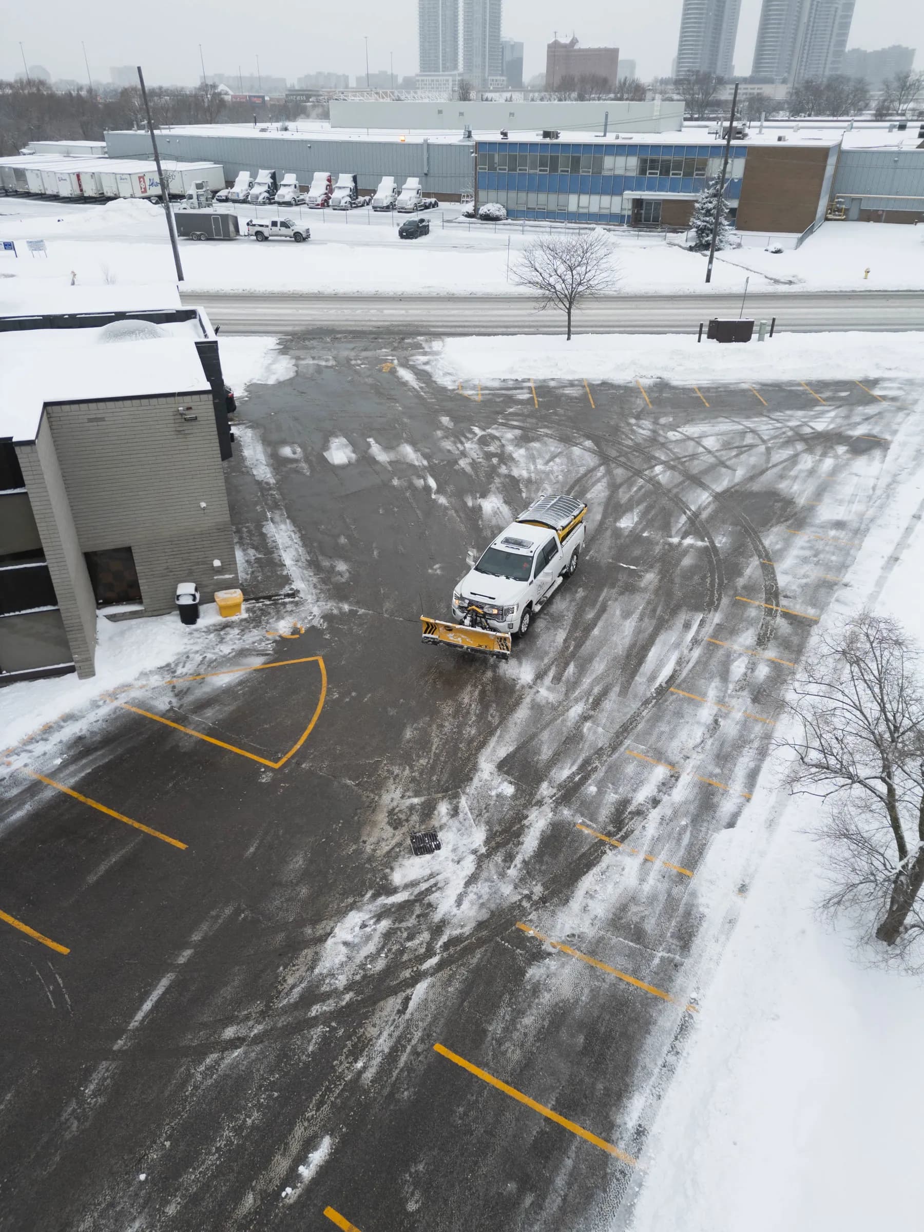 Drone view of parking lot lanes cleared by the Dawn Till Dusk plow truck